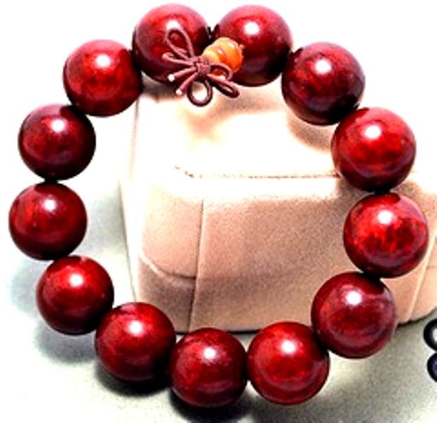 maroon Shamballa bracelet, adorned with large beads, exudes an aura of elegance