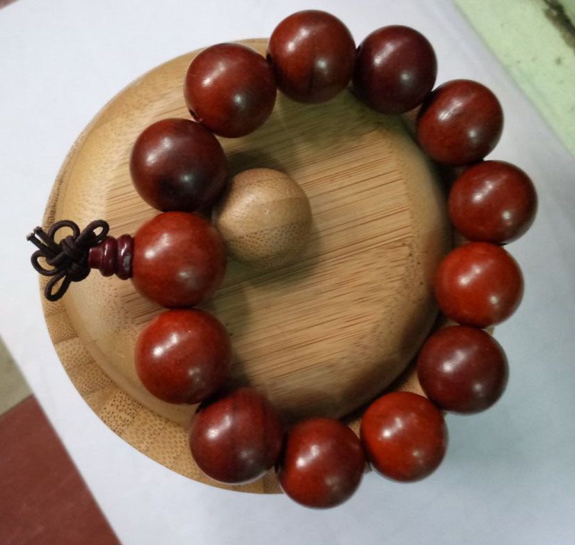 maroon Shamballa bracelet, adorned with large beads, exudes an aura of elegance