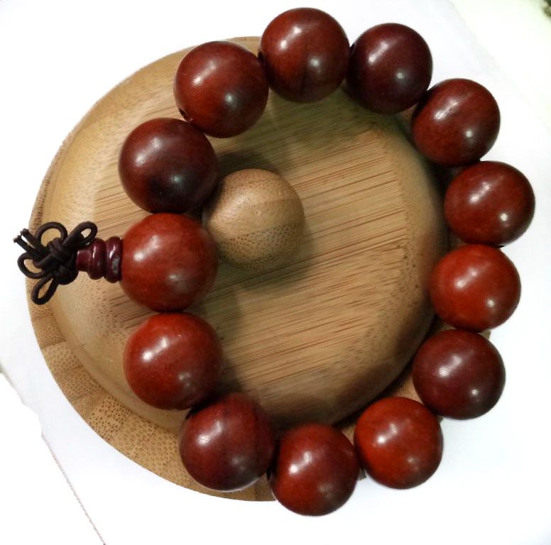 maroon Shamballa bracelet, adorned with large beads, exudes an aura of elegance