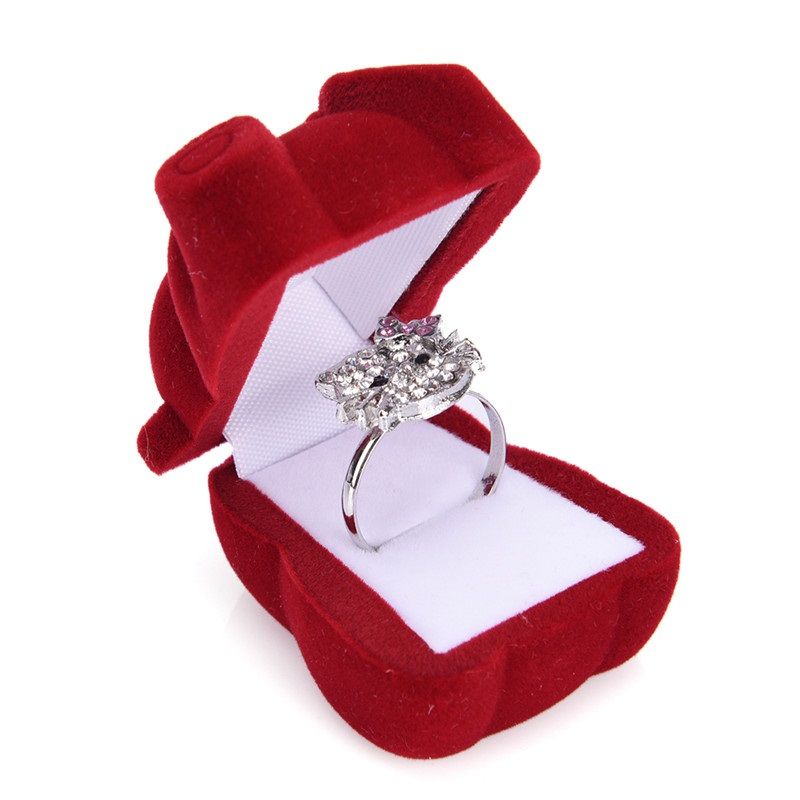 charming red velvet ring box, designed in the shape of a teddy bear, is the perfect fusion of elegance and whimsy,
