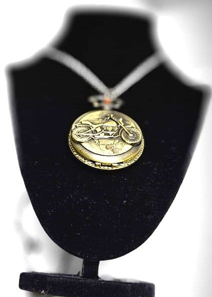 This brass pocket watch, a striking fusion of craftsmanship and legend, embodies the spirit of Ghost Rider with intricate details and a dark, enigmatic aura