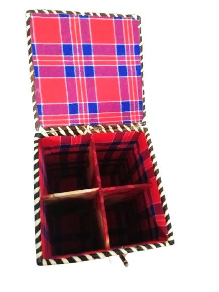 A rectangular gift box made from a Maasai shuka is a striking fusion of cultural tradition and functional elegance
