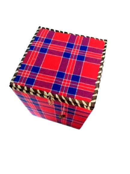 A rectangular gift box made from a Maasai shuka is a striking fusion of cultural tradition and functional elegance