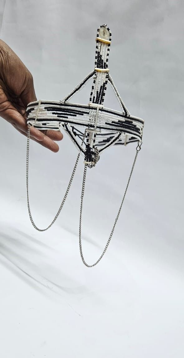 A black and white maasai head gear /face gear with silver decorations very classic and fashionable to have