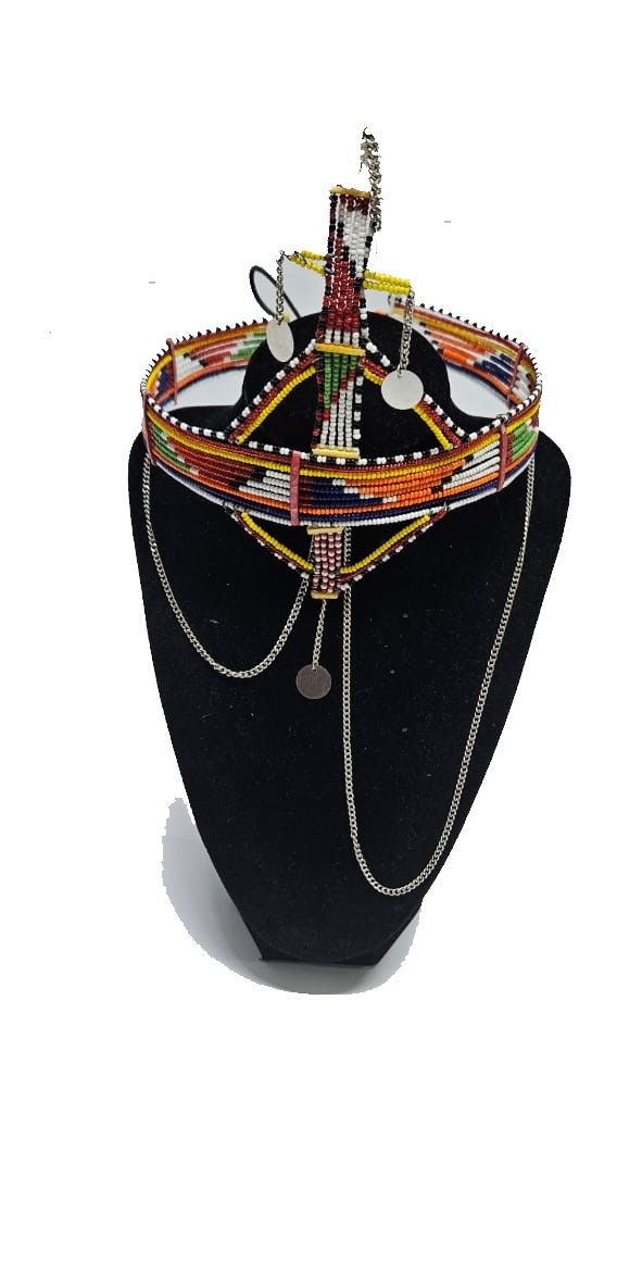 A large red green maasai head gear with some silver daggling decorations very fashionable  and is easy and comfortable to wear