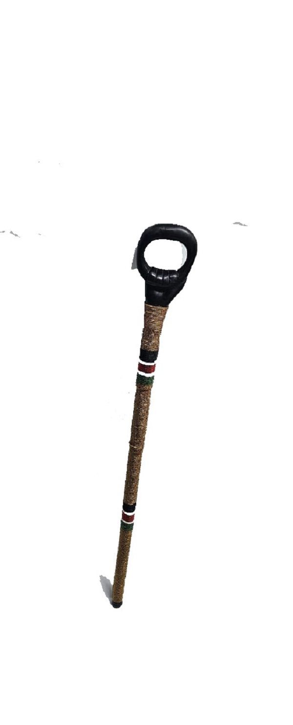 A  black wooden  gold,red, white, black and green beaded walking stick having a circle handle very fashionable to have