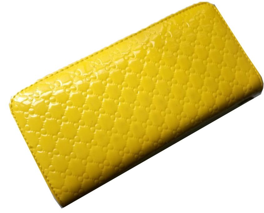 A multicolored knitted scarf and a ladies yellow purse combo very fashionable, durable and comfortable to have .