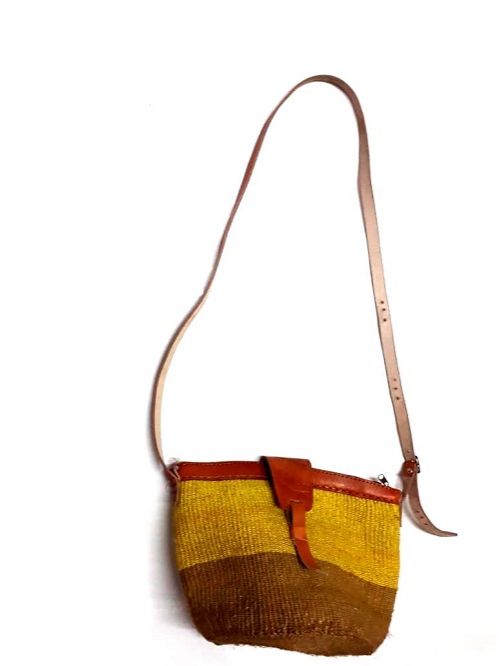 Ladies’ yellow African handcrafted sisal kyondo with leather straps and yellow crystal chandelier earrings combo very fashionable and durable .
