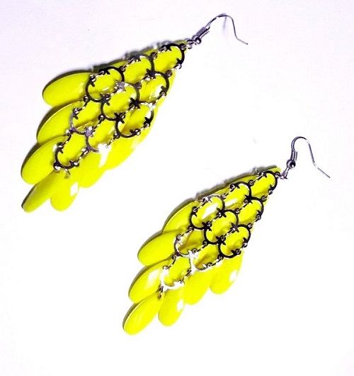 Ladies’ yellow African handcrafted sisal kyondo with leather straps and yellow crystal chandelier earrings combo very fashionable and durable .