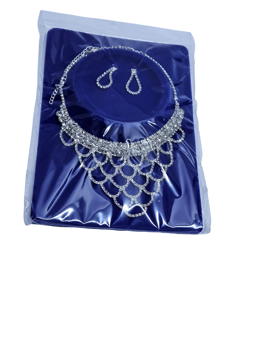 Ladies embellished silver crystal jewelry set of a necklace and a matching earrings fashionable and durable .