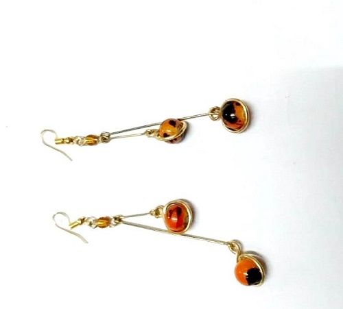 Ladies orange crystal drop down earrings are a stunning and elegant accessory designed to add a touch of color and sparkle to any outfit