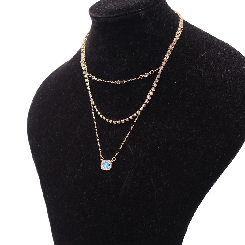Elegant Multi-Layered Gold Necklace With Blue Gem Pendant. Designed To Enhance Any Outfit, This Piece Is Perfect For Formal Occasions, Casual Wear, Or As A Statement Accessory