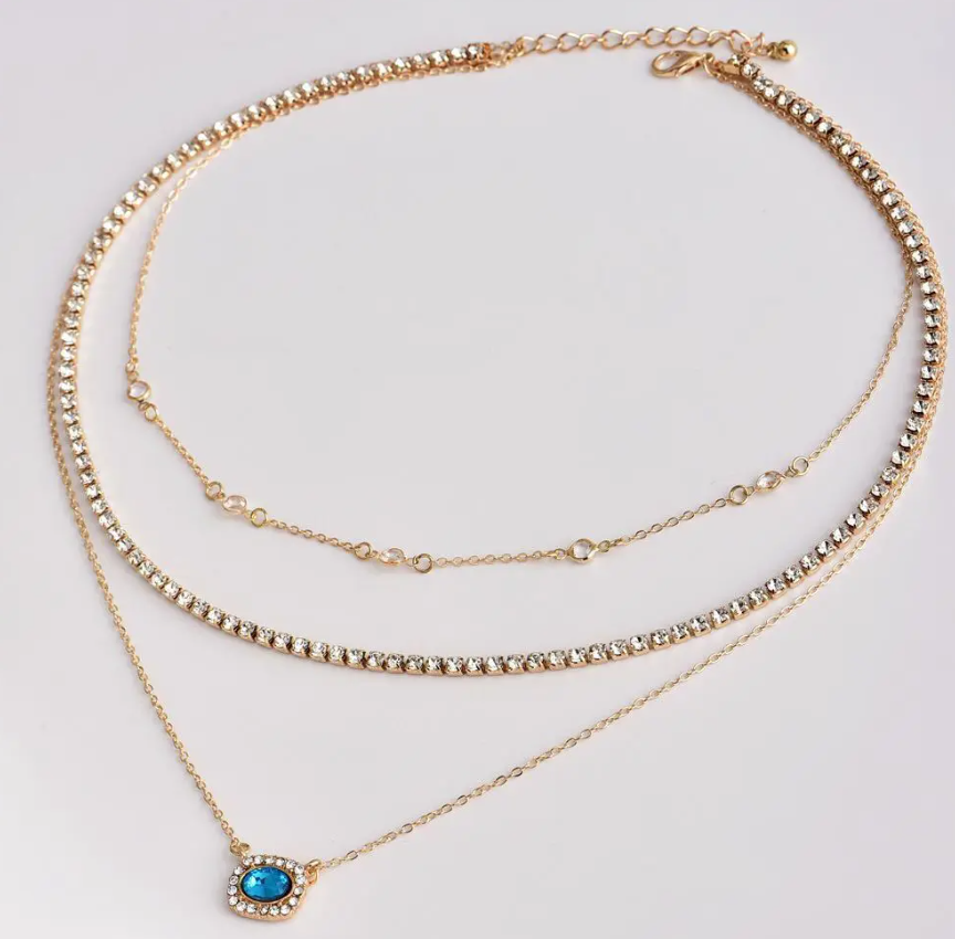 Elegant Multi-Layered Gold Necklace With Blue Gem Pendant. Designed To Enhance Any Outfit, This Piece Is Perfect For Formal Occasions, Casual Wear, Or As A Statement Accessory
