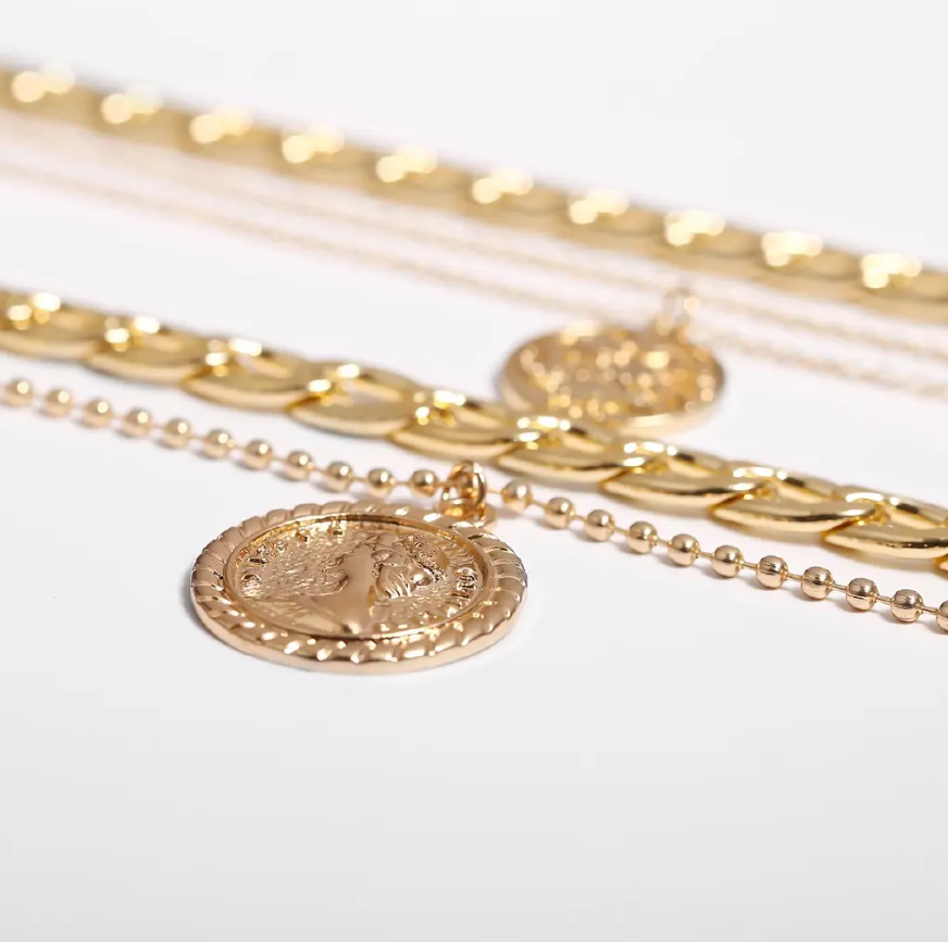Bold & Trendy Gold Layered Chain Necklace With Coin Pendants. Make A Fashion Statement With This Gorgeous Layered Gold Necklace! Featuring A Mix Of Chunky Chains And Delicate Layers