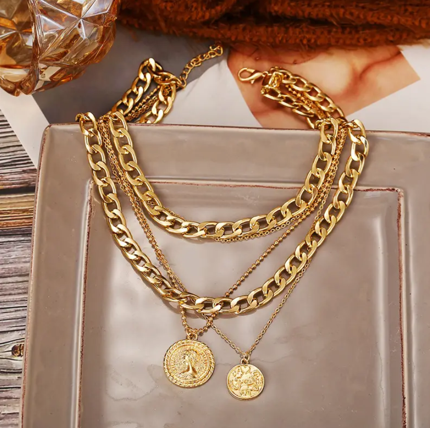 Bold & Trendy Gold Layered Chain Necklace With Coin Pendants. Make A Fashion Statement With This Gorgeous Layered Gold Necklace! Featuring A Mix Of Chunky Chains And Delicate Layers