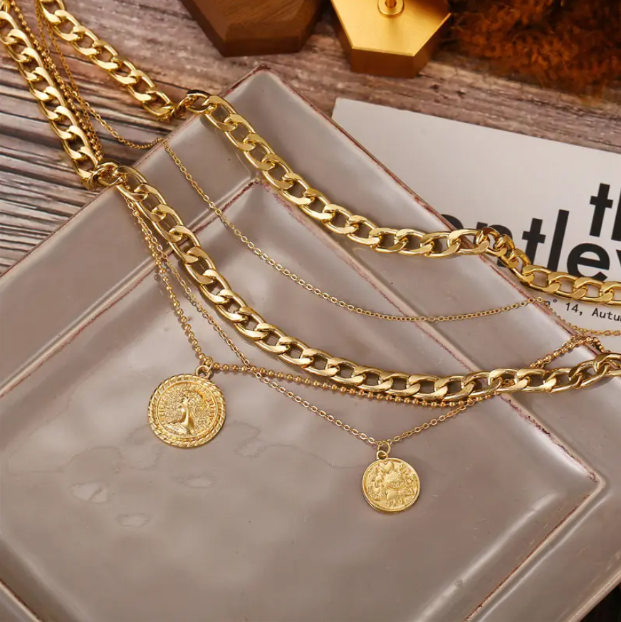 Bold & Trendy Gold Layered Chain Necklace With Coin Pendants. Make A Fashion Statement With This Gorgeous Layered Gold Necklace! Featuring A Mix Of Chunky Chains And Delicate Layers