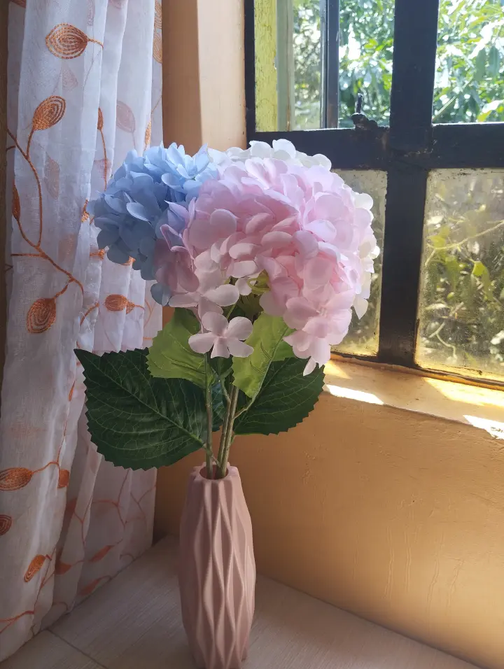 Artificial hydrangea flower  with two leaves (set of three flower stems with two leaves of different colors) in a plastic nordic vase
