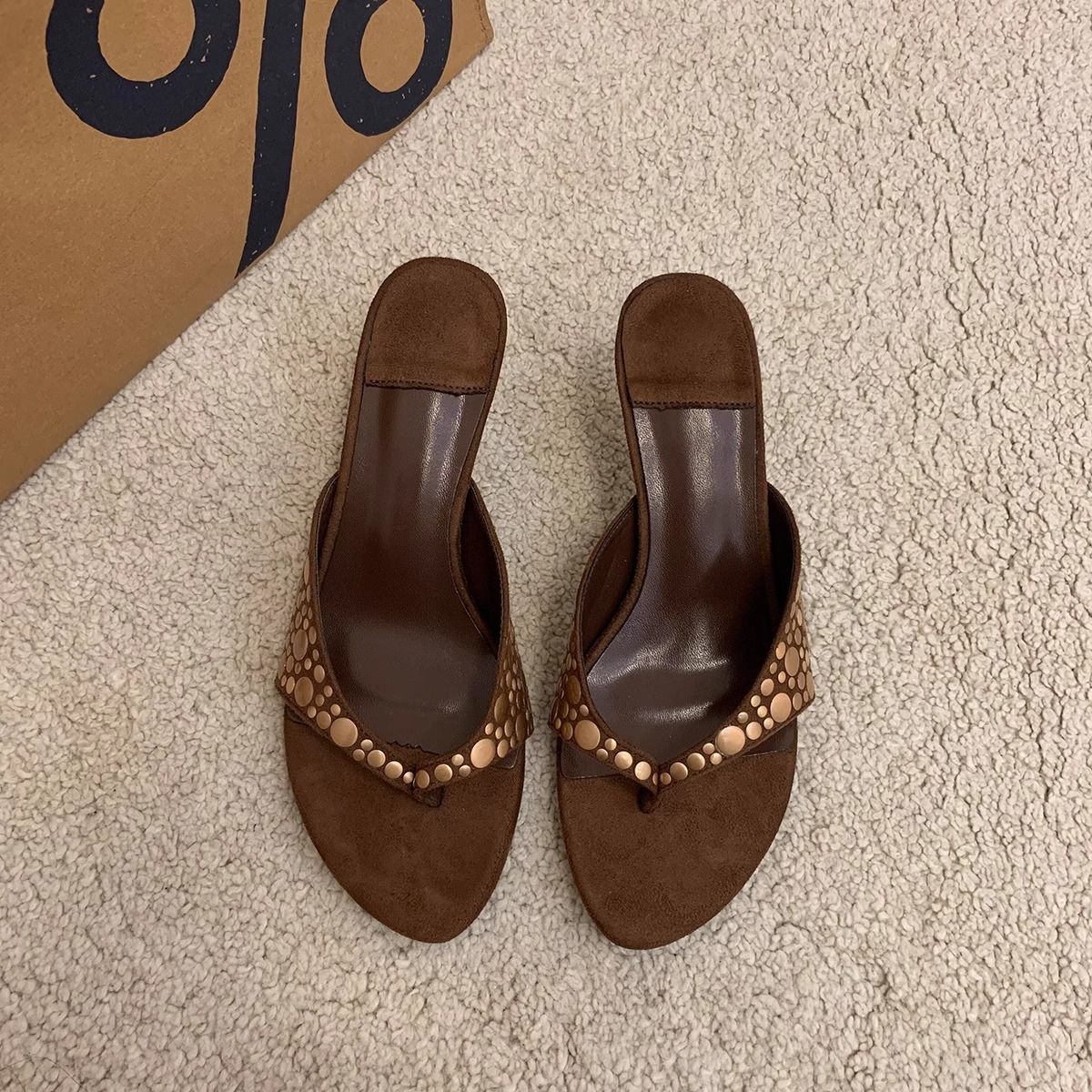 Women's brown suede sandals with rivets and thin heels, featuring a herringbone pattern and a slip-on design. These versatile high-heeled shoes are perfect for women who want to add a touch of Open sh