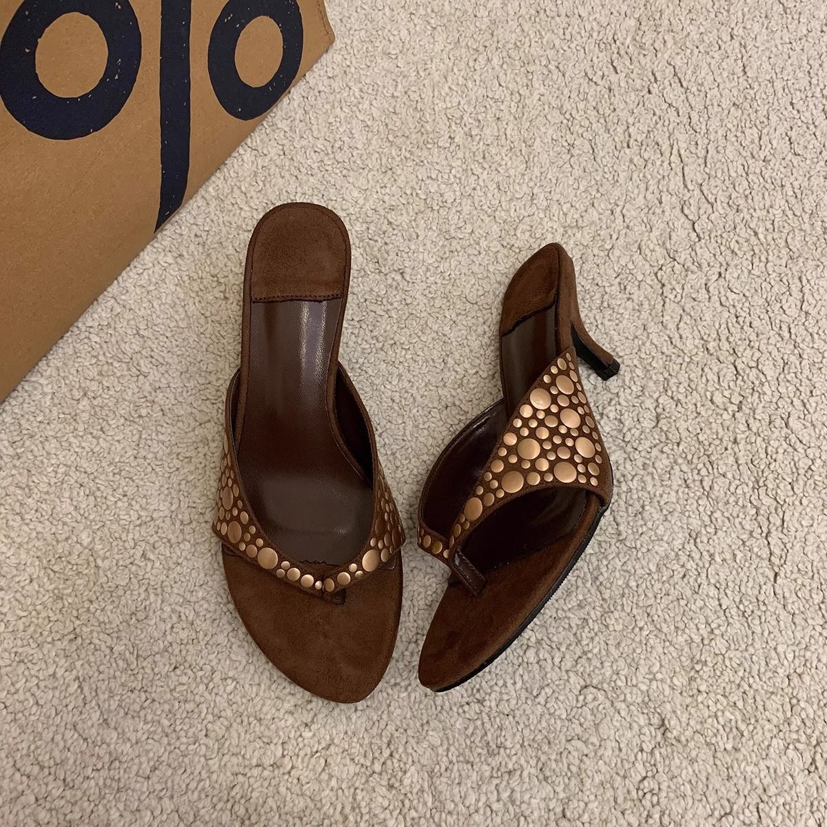 Women's brown suede sandals with rivets and thin heels, featuring a herringbone pattern and a slip-on design. These versatile high-heeled shoes are perfect for women who want to add a touch of Open sh