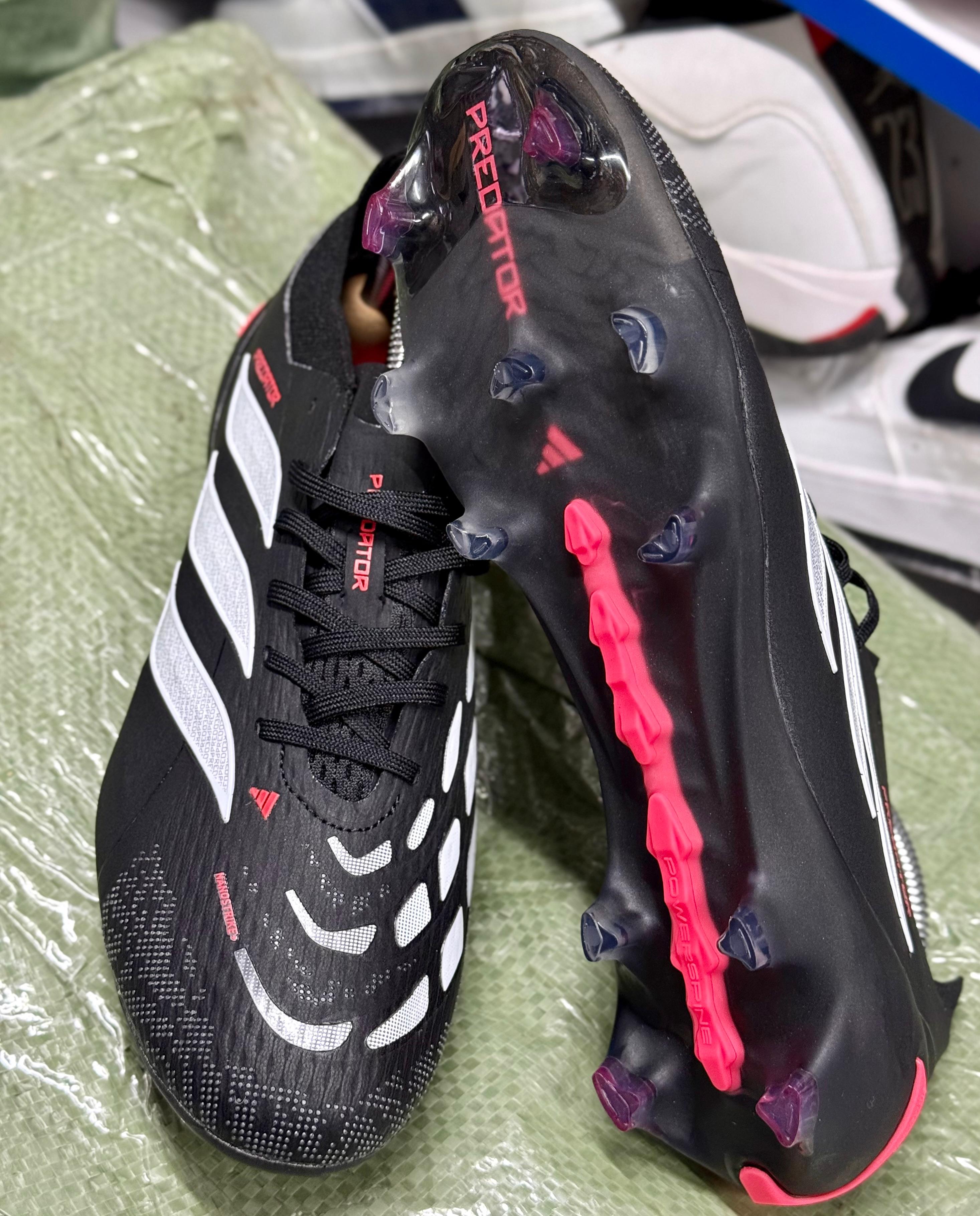 Predator Accuracy football boots, known for their rubber elements designed to enhance ball spin and control.