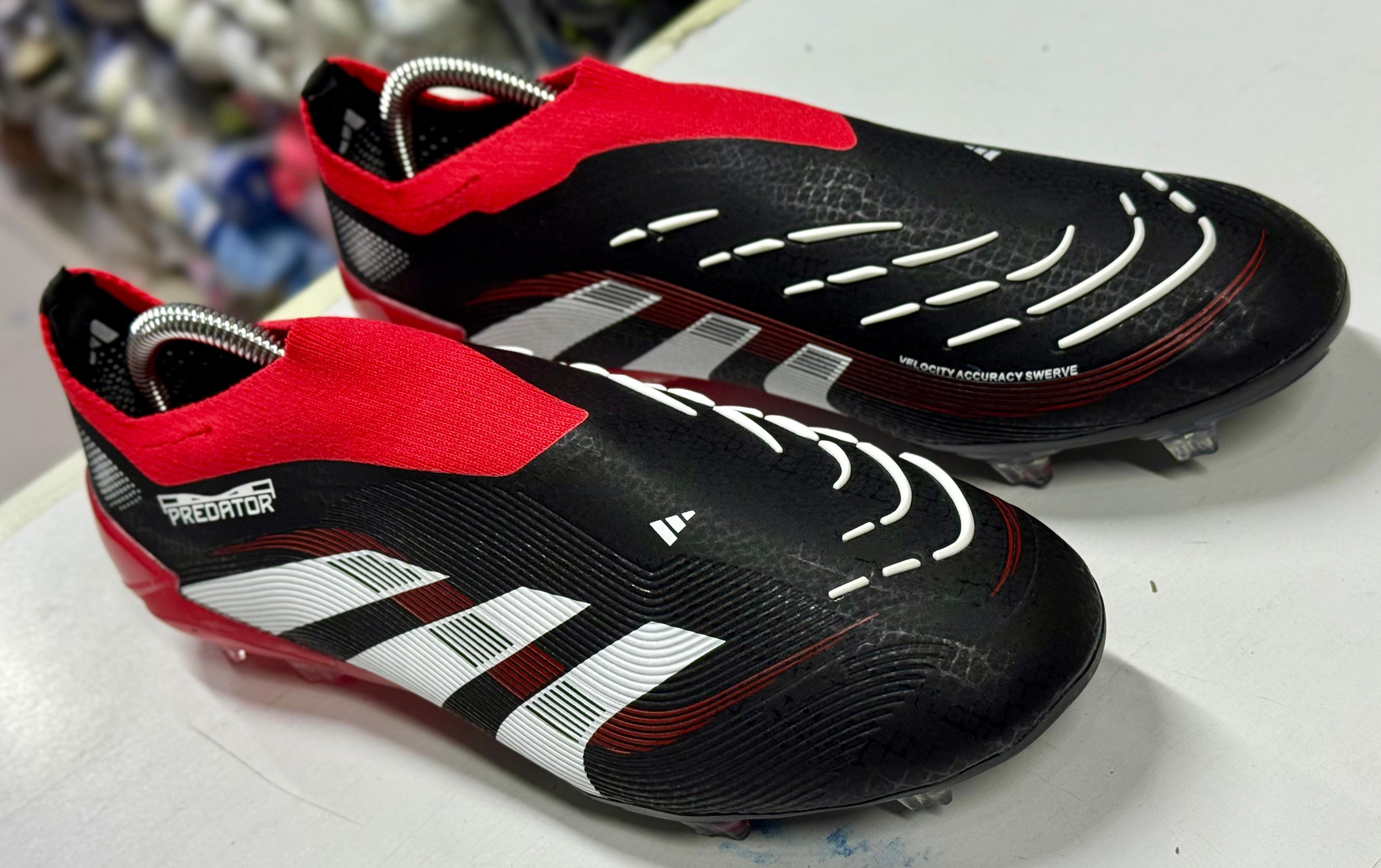 Predator Accuracy football boots, known for their rubber elements designed to enhance ball spin and control.