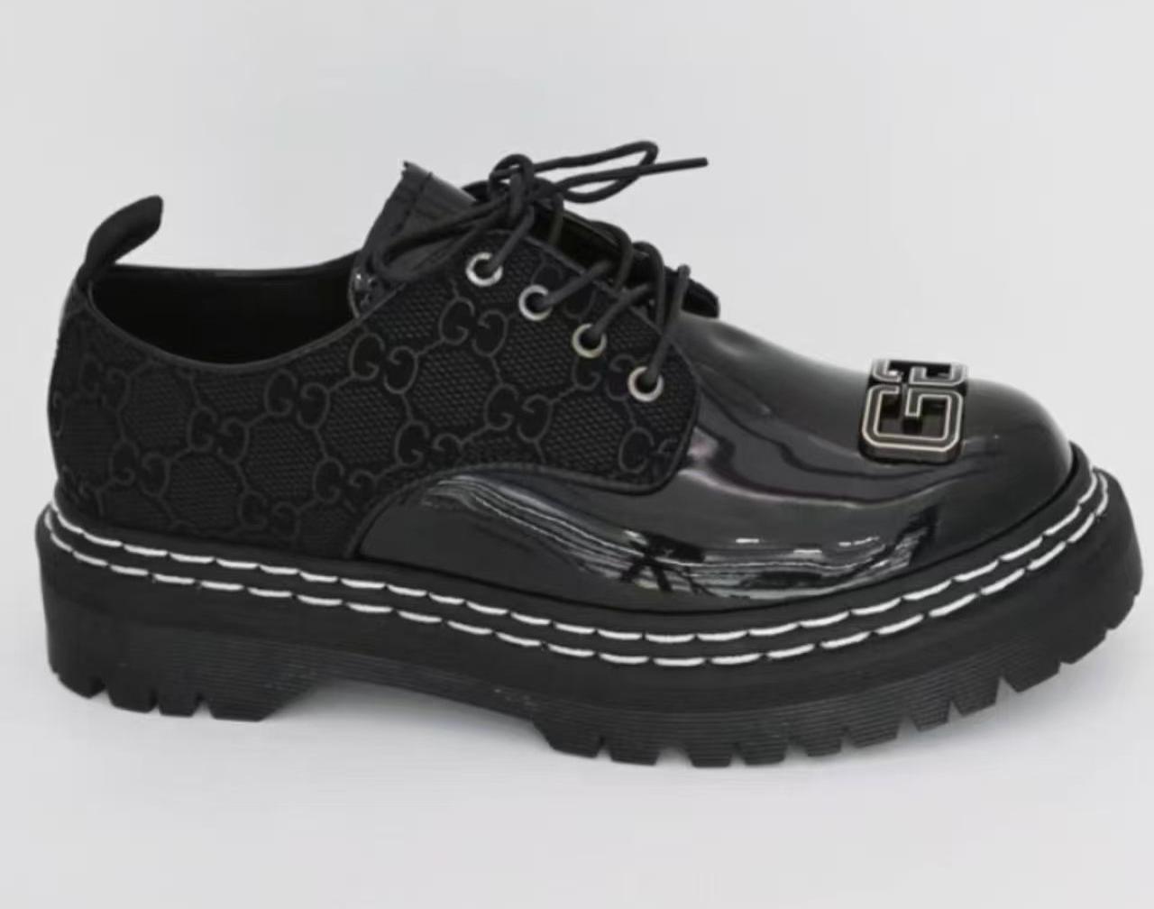 Original Leather Dr Marten black patent leather-style lace-up shoes with a thick, (Dr Martin)lugged sole and a metallic embellishment on the vamp. very comfortable and classy official cassual loe
