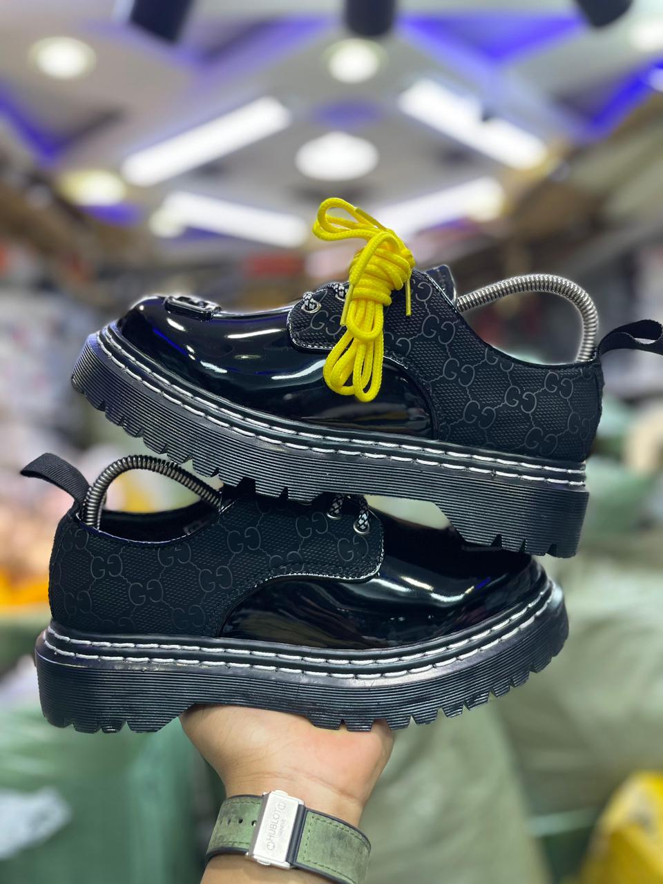 Original Leather Dr Marten black patent leather-style lace-up shoes with a thick, (Dr Martin)lugged sole and a metallic embellishment on the vamp. very comfortable and classy official cassual loe