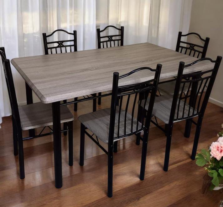 Executive 6 sitter dinning table Executive 6-Seater Dining Table, designed to combine elegance, durability, and comfort. The set includes a rectangular table with a light grey wood-finish top and stur