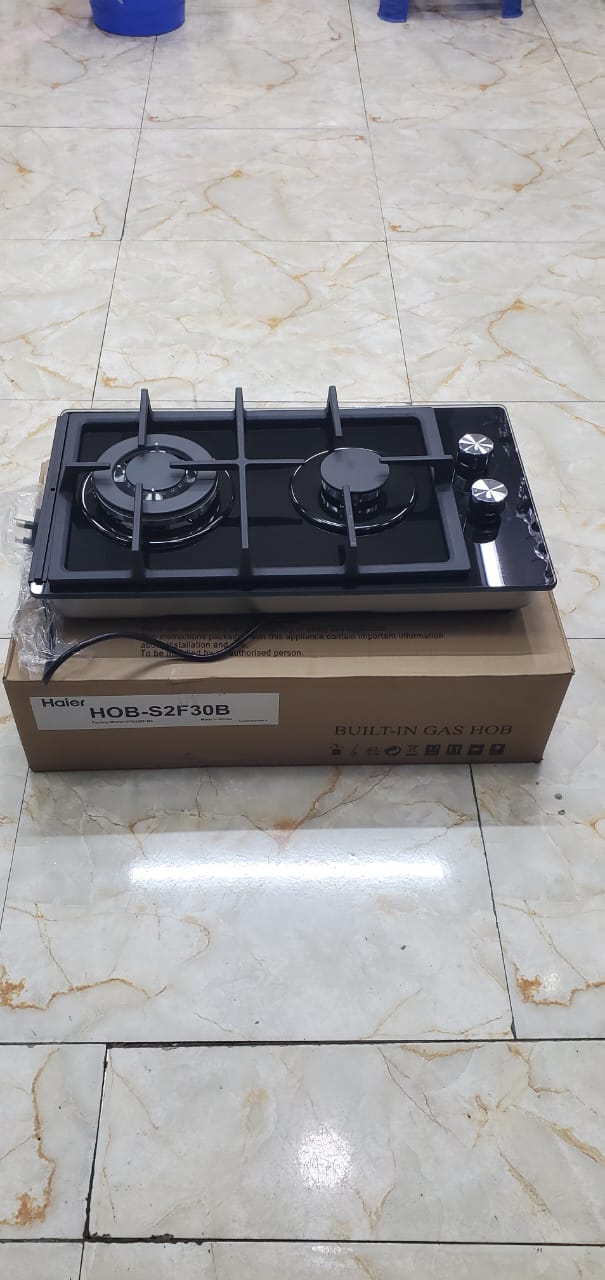 Haier 2-Burner Glass Inbuilt Hob Cooker – Gas Stove with Powerful Wok Burner, Sleek inbuilt design for modern kitchen countertops, Automatic ignition and precise flame control, Heavy-duty cast iron.