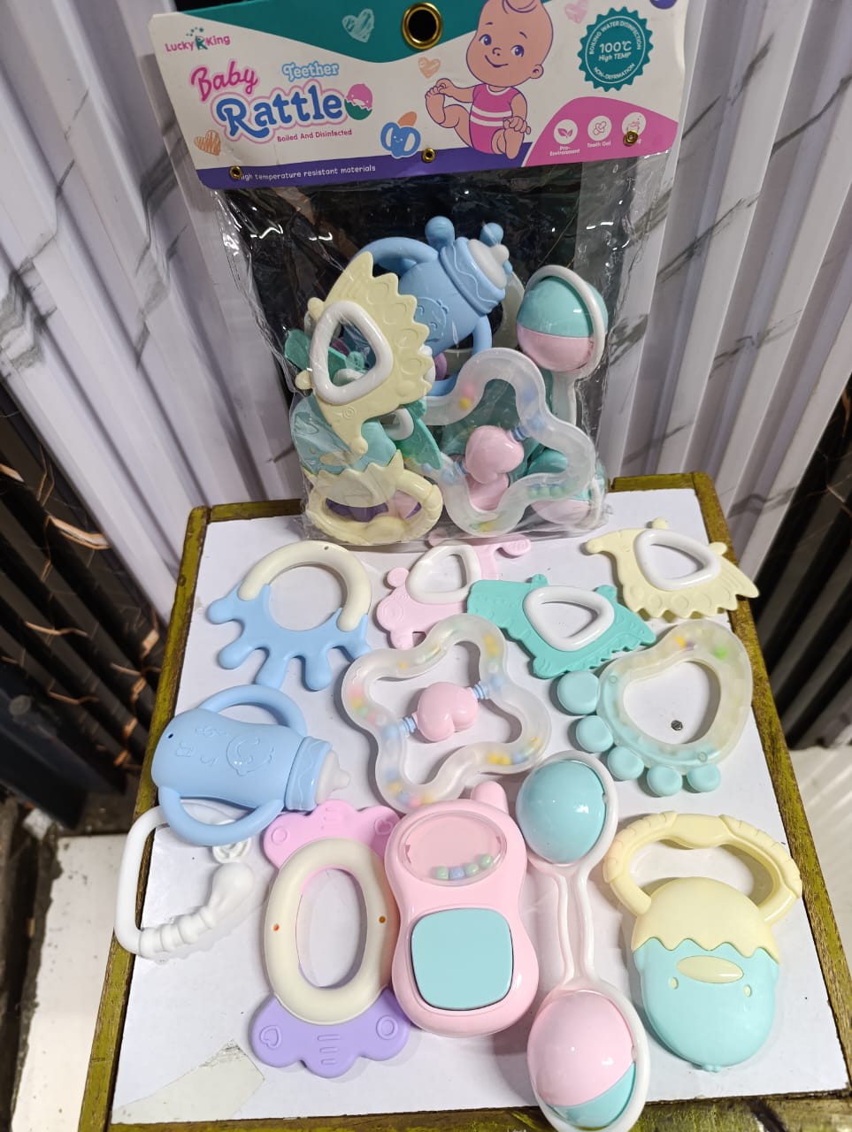 12 PCS BABY RATTLES WITH TEETHERS - 12 styles pattern design attracts attention be used as a necklace with a rope a teething pacifier prevent losing it .