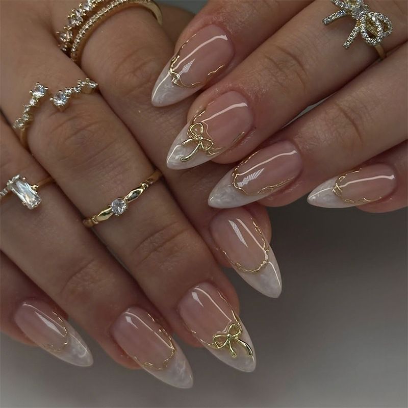 A detachable and wearable nail plate set for ladies with exquisite French bow, almond gold edge lines and delicate nail art