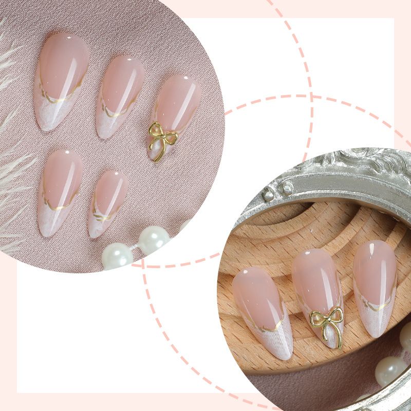A detachable and wearable nail plate set for ladies with exquisite French bow, almond gold edge lines and delicate nail art