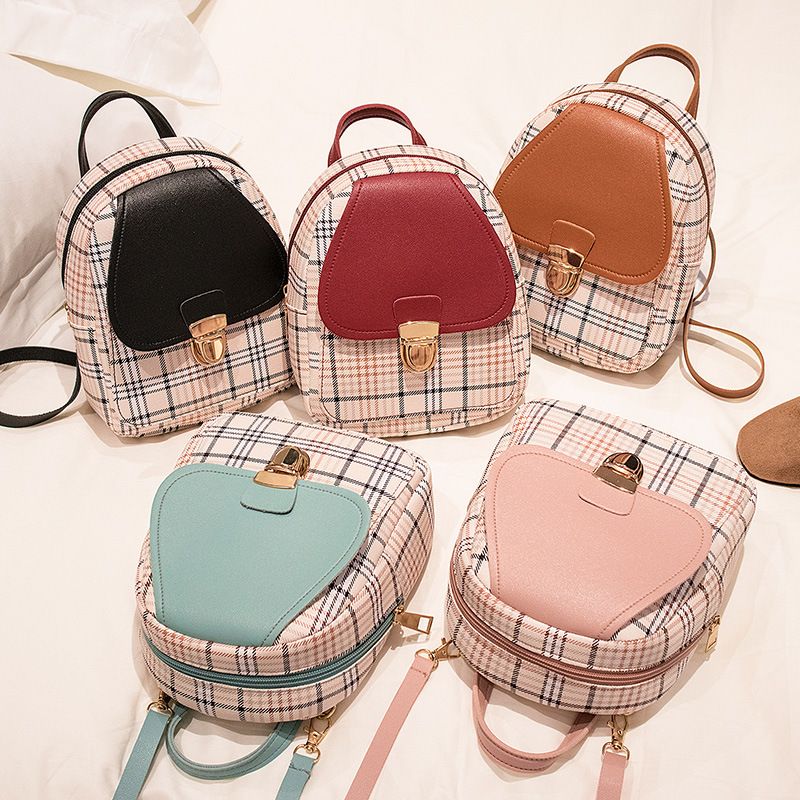 The new checkered backpack is a trendy Korean-style bag. It's a small hand-held bag with a lock and a single-shoulder crossbody bag for students. It's fashionable and versatile