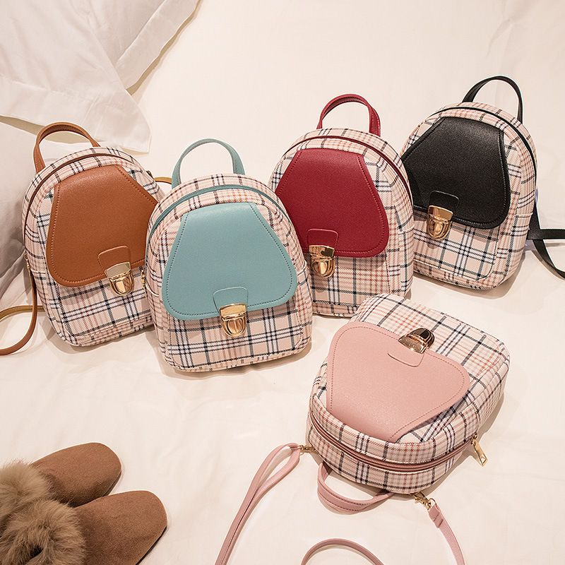 The new checkered backpack is a trendy Korean-style bag. It's a small hand-held bag with a lock and a single-shoulder crossbody bag for students. It's fashionable and versatile
