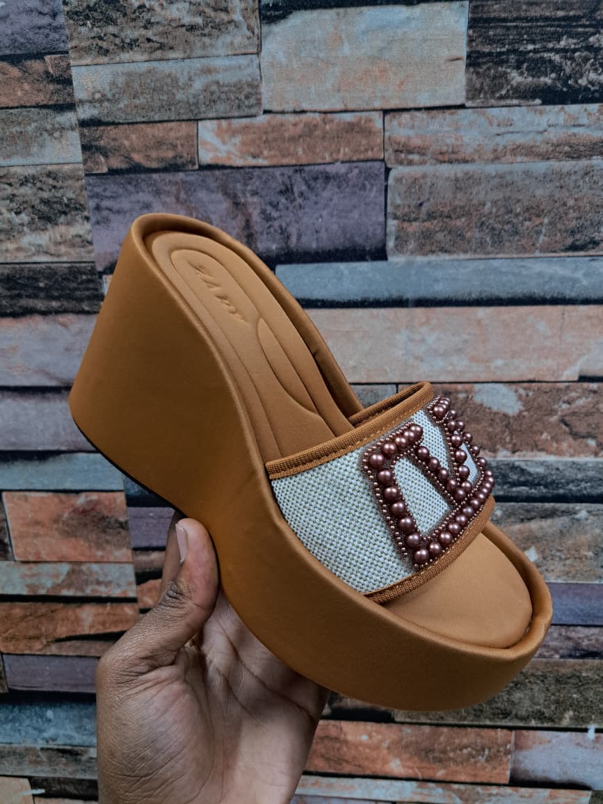 *_🔥Platforms Sandals. It Gives a striking and modern  appearance. A Cushioned  footbed for comfort. A white mesh panel adorned with beads embellishments💥_*
Available in :Black,Brown,and Red