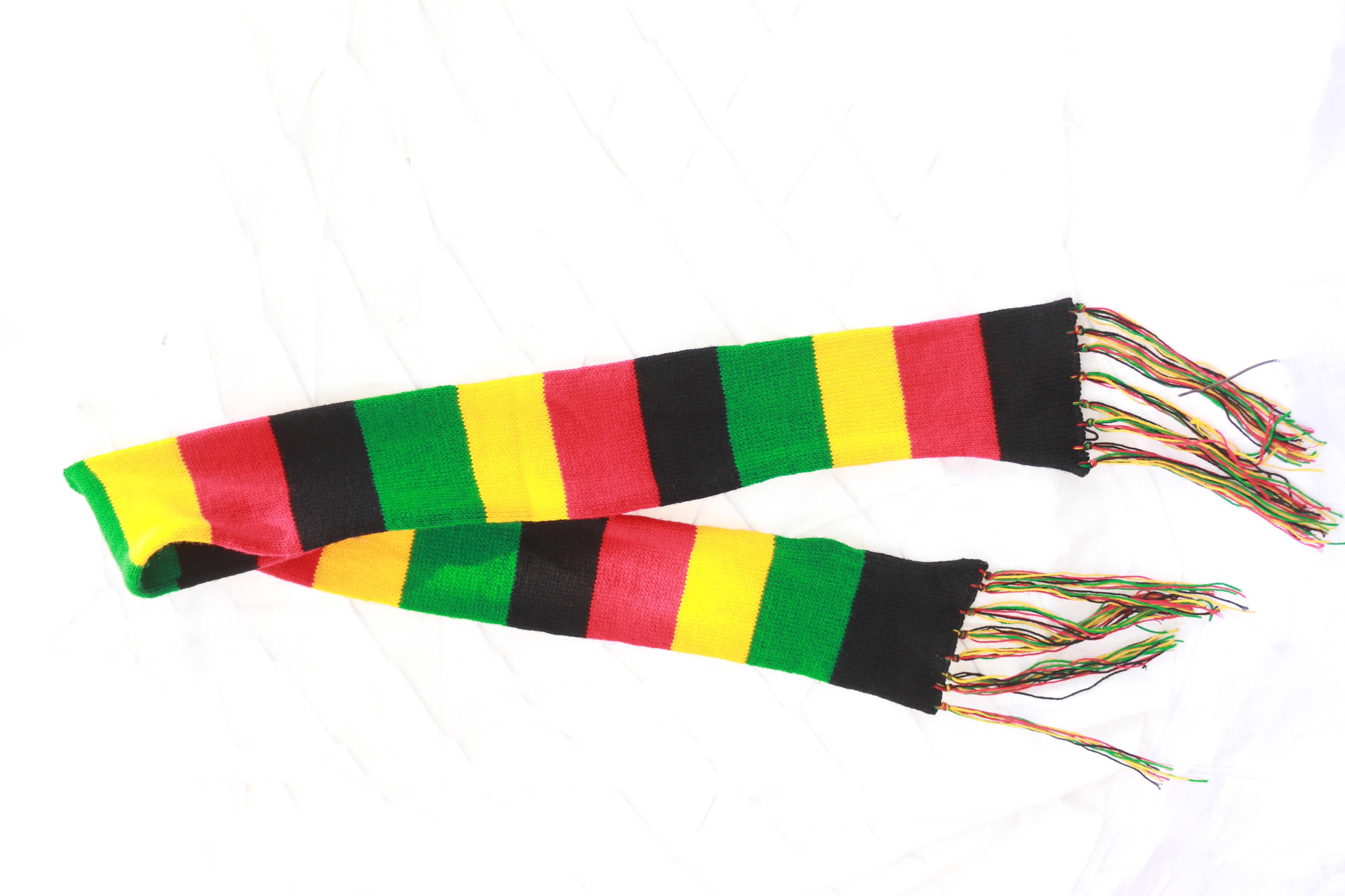 vibrant multicolor hand-knit scarf is a cozy and stylish accessory Crafted with care and attention to detail