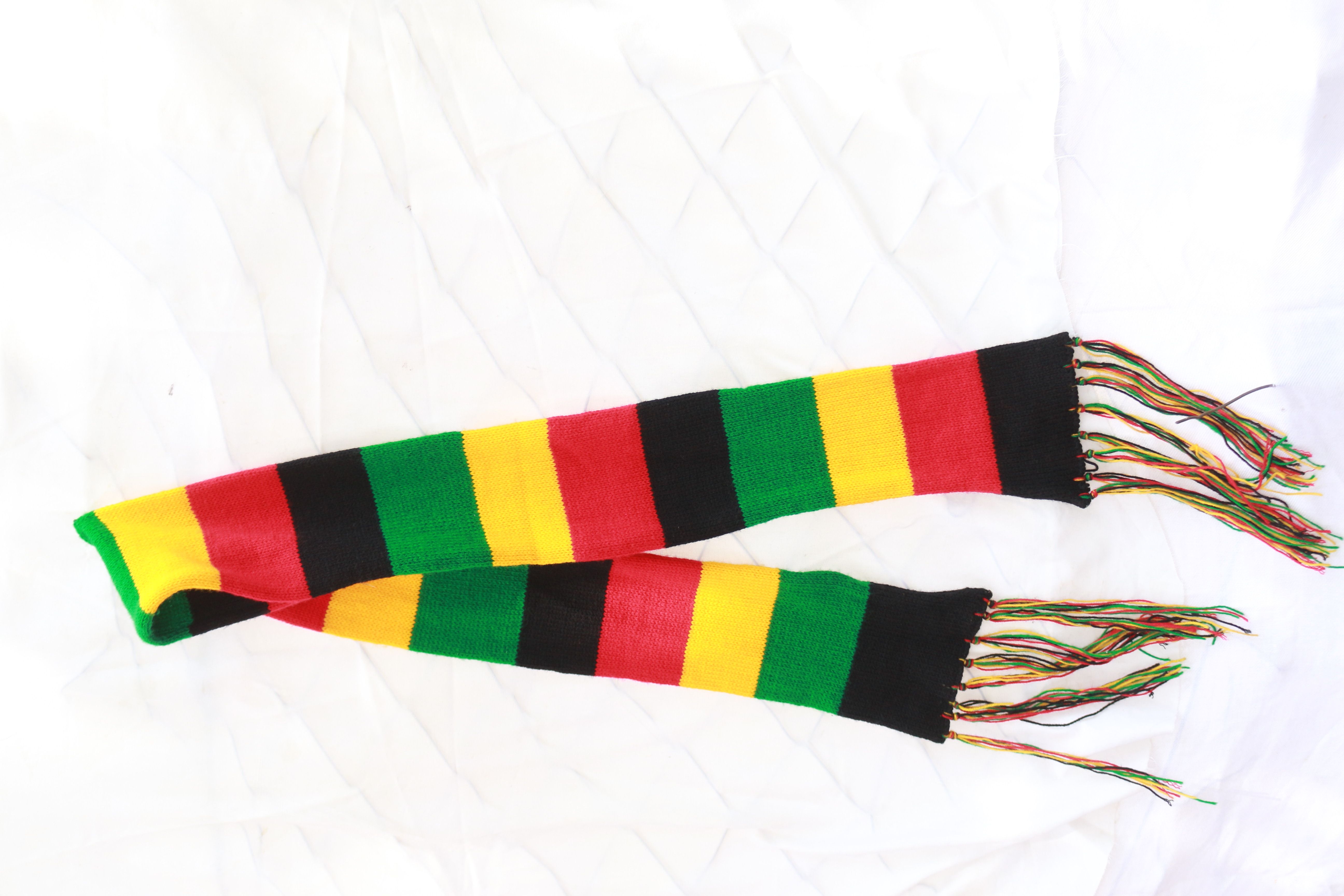 vibrant multicolor hand-knit scarf is a cozy and stylish accessory Crafted with care and attention to detail