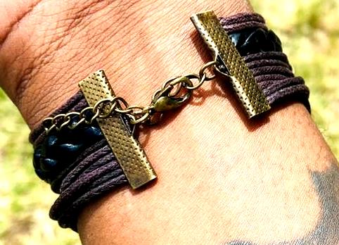 A multi-strand leather bracelet adorned with cobweb decorations sounds like a unique and edgy accessory