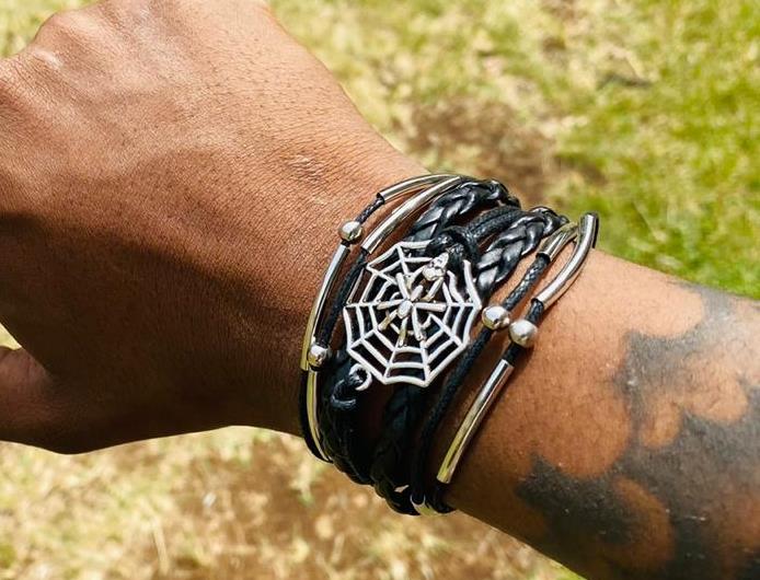 A multi-strand leather bracelet adorned with cobweb decorations sounds like a unique and edgy accessory
