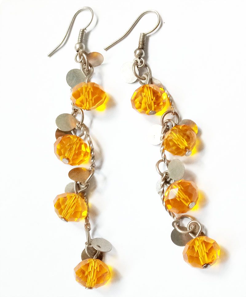 orange crystal long earrings are a striking accessory that exudes elegance and charm The earrings are crafted from high-quality materials