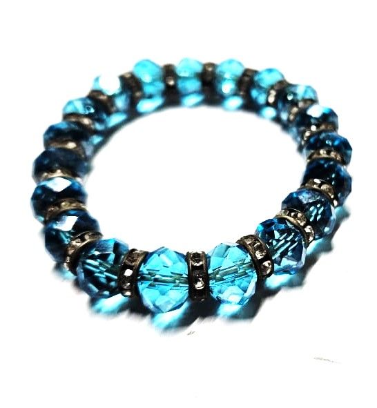 breathtaking blue crystal bracelet, a masterpiece of craftsmanship adorned with an array of meticulously crafted small embellishments.