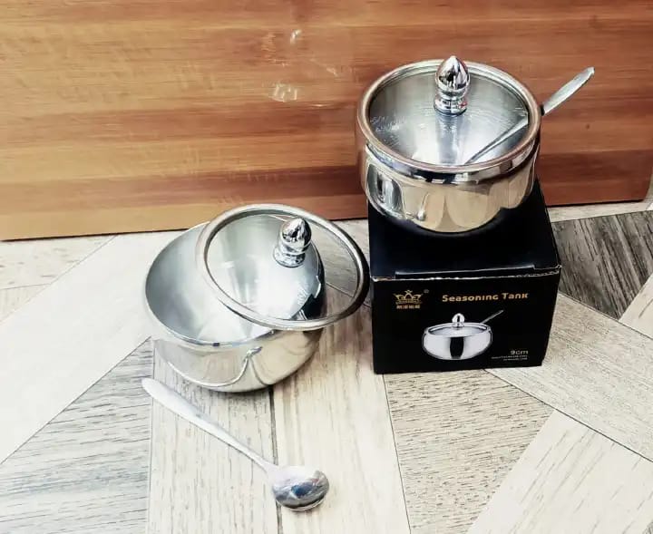 Stainless steel kitchen sugar bowl with glass lid.