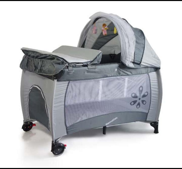 Foldable baby cot; has a changing mat, canopy with mosquito net, hanging toys
