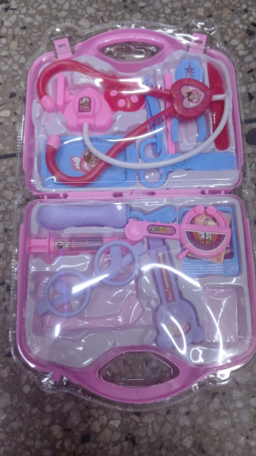 A Generic Kids Doctor Kit Pretend Play Set Featuring a pink carrying case.The set typically includes tools like a stethoscope, syringe, and thermometer designed to help children feel at ease with doct