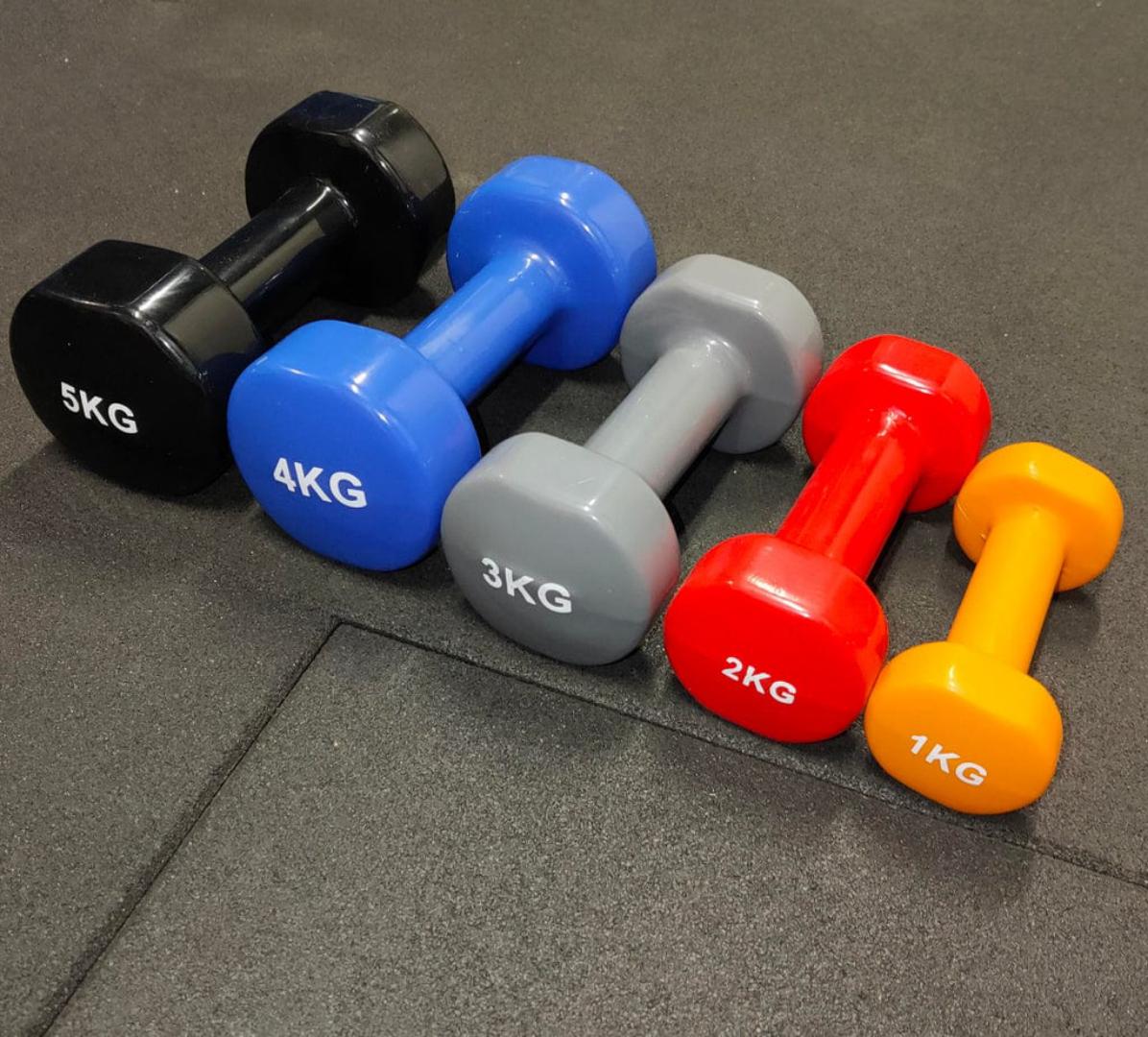 Hexagonal dumbbells ranging in weight from 1kg to 5kg.