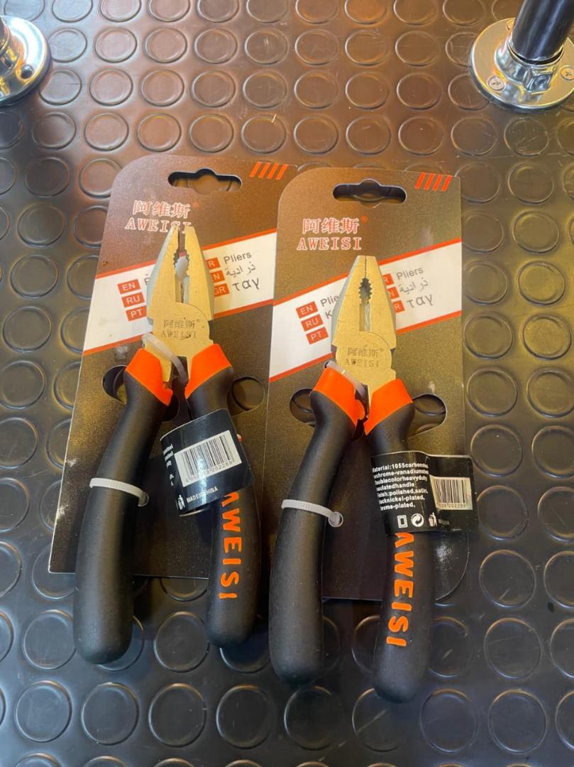 Combination pliers packaged with ergonomic black and orange rubber handles and a polished metal head.