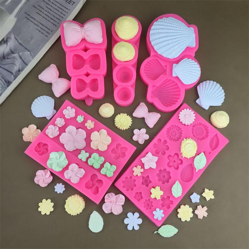 Silicone molds for pillows, bows, conch shells, frangipani flowers, and herbs; fondant cakes; chocolate decorations and accessories molds.