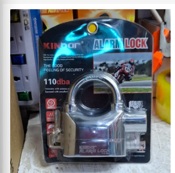 Kinbar High-Security Alarm Padlock. It features a built-in movement and shock-triggered sensor alarm. The siren is a loud 110dB. It has a durable zinc alloy body and hardened steel shackle. It can