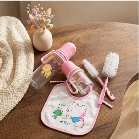 7pcs Baby Feeding Set  A full feeding kit that includes two feeding bottles, a bib, bottle cleaning brushes, ear buds, and a baby pacifier. Made with baby-friendly materials and convenient accessories