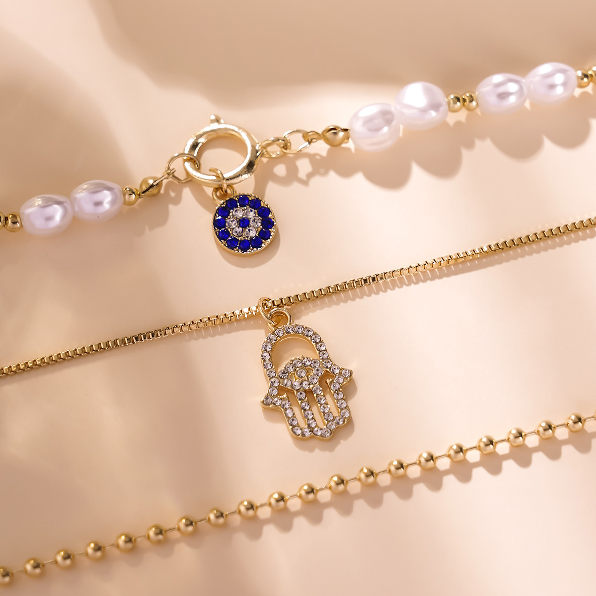 Cross border hot selling 2025 new European and American exaggerated diamond inlaid multi-layer necklace women's pearl eye pendant chain set